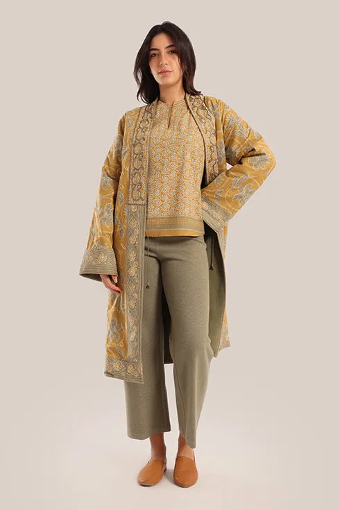 Reversible long sleeve coat in polar fleece and printed cotton with embroidered collar, and functional pockets.