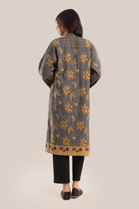 Reversible long sleeve coat in polar fleece and printed cotton with embroidered collar, and functional pockets.