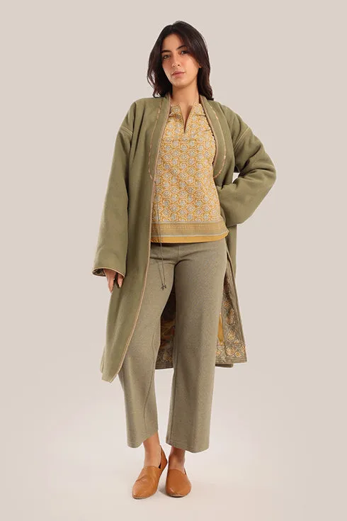Reversible long sleeve coat in polar fleece and printed cotton with embroidered collar, and functional pockets.