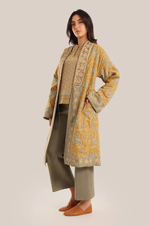Reversible long sleeve coat in polar fleece and printed cotton with embroidered collar, and functional pockets.